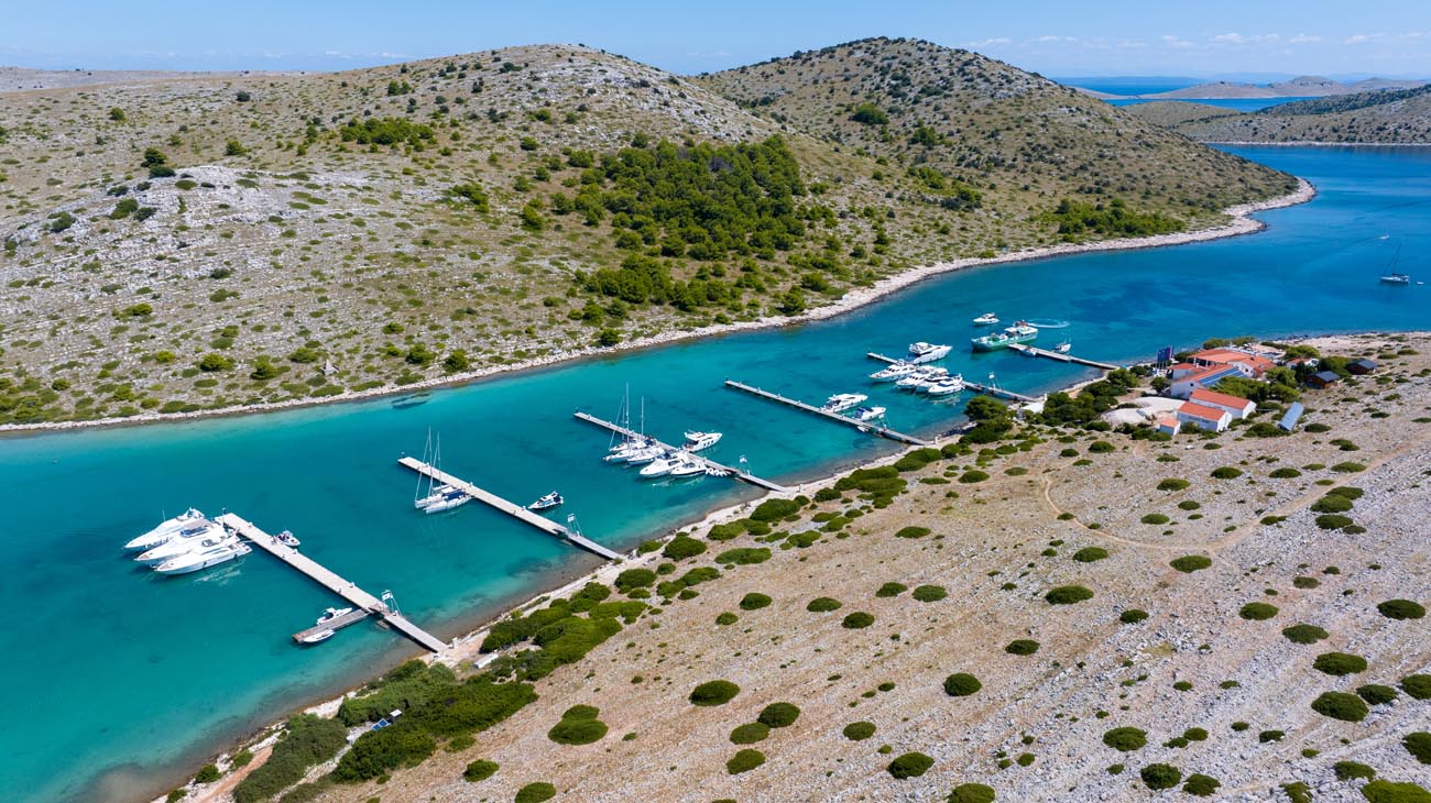 ACI Marina Piškera surrounded by Kornati islands with boats and clear Adriatic sea