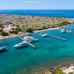 Sailing yachts berthed at ACI Marina Piškera with floating pontoons and sheltered bay