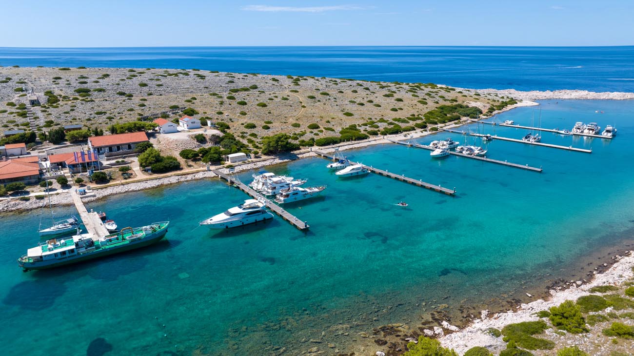 Sailing yachts berthed at ACI Marina Piškera with floating pontoons and sheltered bay