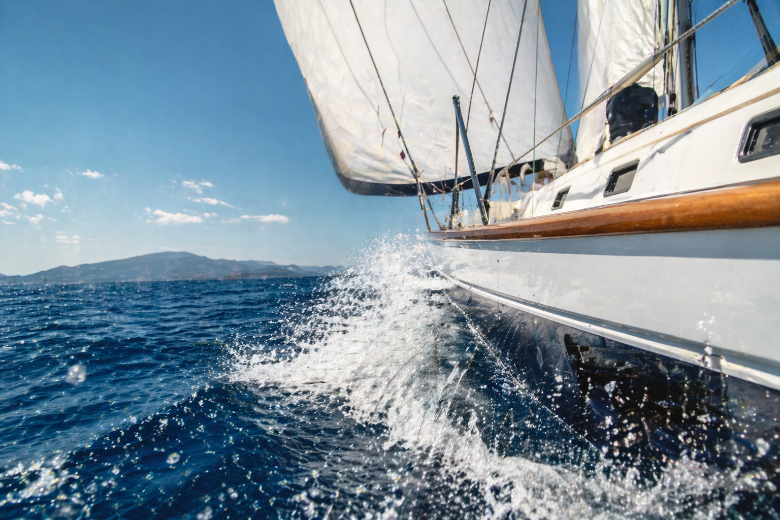 A sailing yacht navigating the crisp blue Adriatic sea in spring, showcasing the active sailing conditions and open horizons.