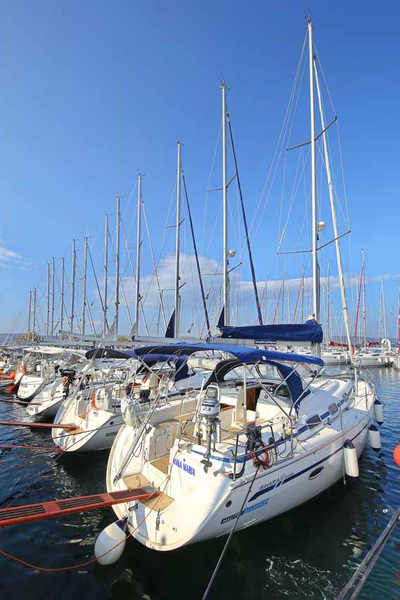 Anna Maria docked in a prestigious marina, showcasing sleek lines and elegant sails.