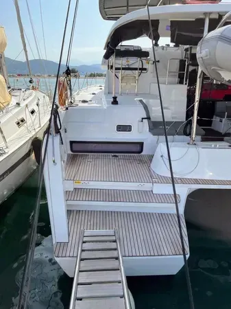 Elegant stern view of Tethys showcasing teak steps and inviting water access.