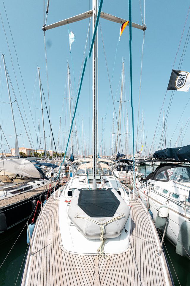 Evita docked in a vibrant marina, showcasing its sleek lines and elegant design.