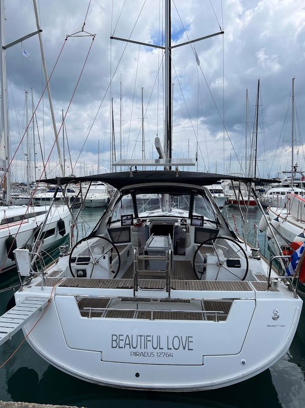 Sleek exterior of Beautiful Love showcasing modern design and luxurious marina setting.