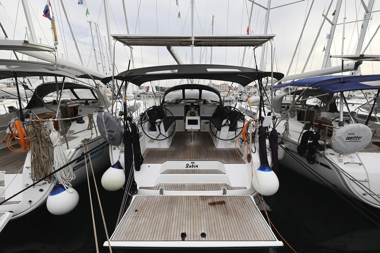 Sleek stern view of the Rubin yacht, showcasing its elegant design and marina setting.
