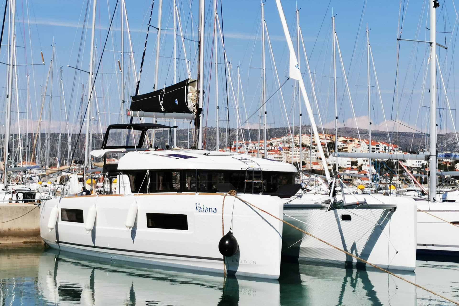 Elegant Vaiana docked in a serene marina, showcasing its sleek profile and luxurious design.
