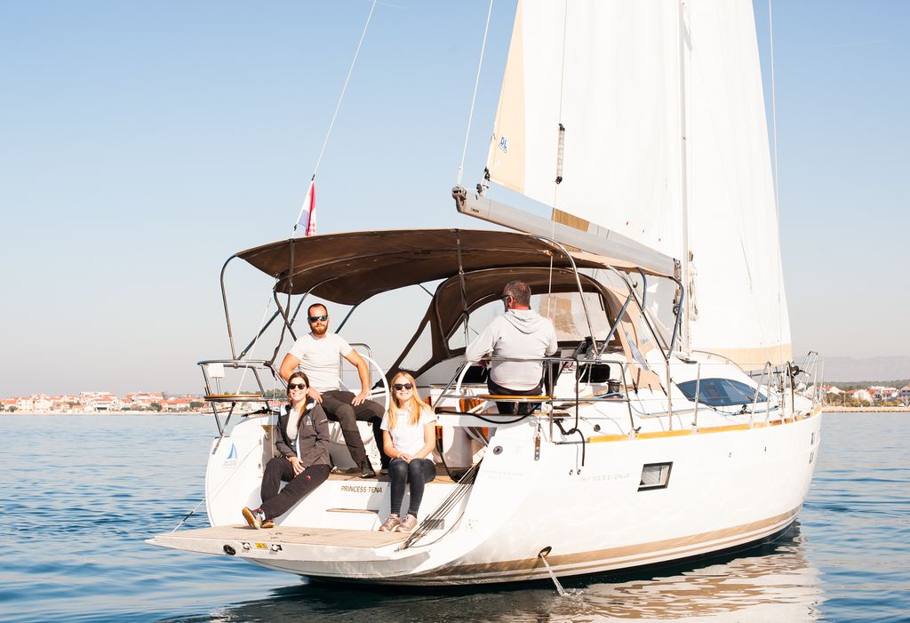 Princess Tena cruising elegantly with guests enjoying the sun on the aft deck.