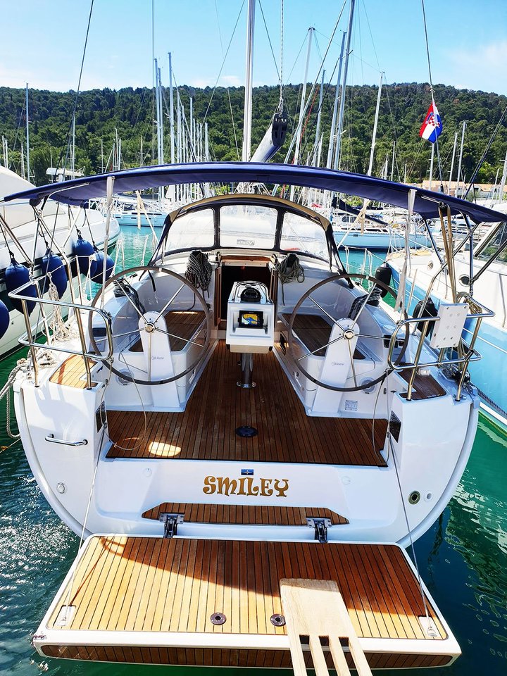 Elegant stern view of the Smiley yacht showcasing its spacious teak deck and dual helms.