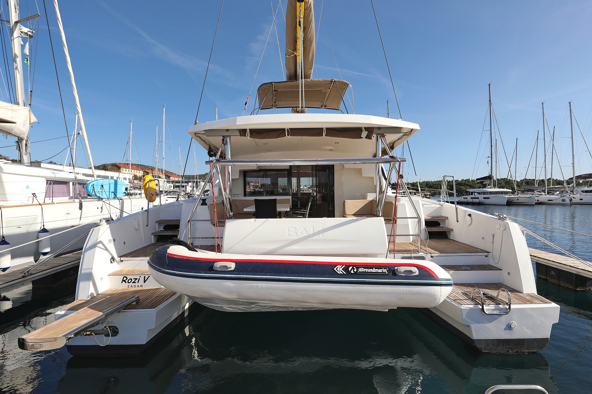 Sleek profile of Rozi V. showcasing its luxurious exterior and spacious aft deck.