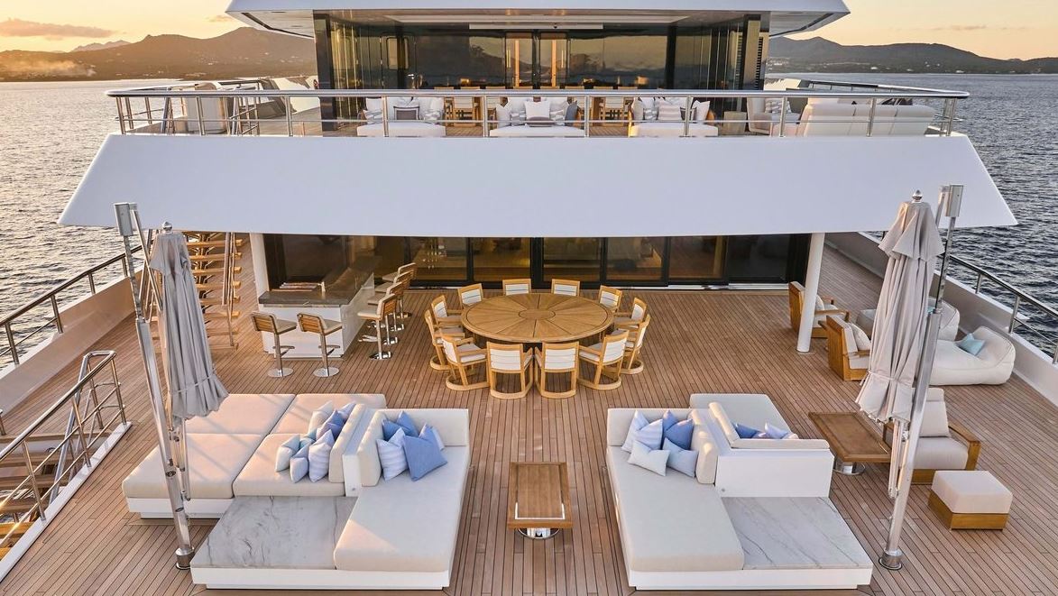 Spacious outdoor dining area on Custom Renaissance, featuring elegant furnishings and stunning views.