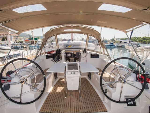 Spacious and elegant helm of the Jeanneau Sun Odyssey 449 2018, featuring dual steering wheels and modern navigation equipment.