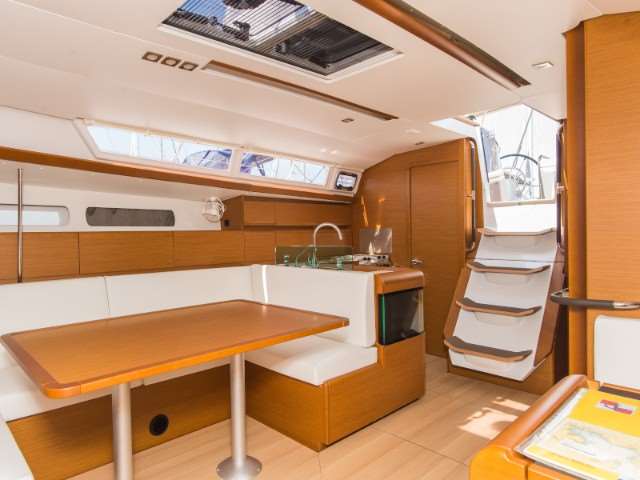 Bright and modern interior of the Jeanneau Sun Odyssey 449, featuring elegant wood finishes and ample natural light.