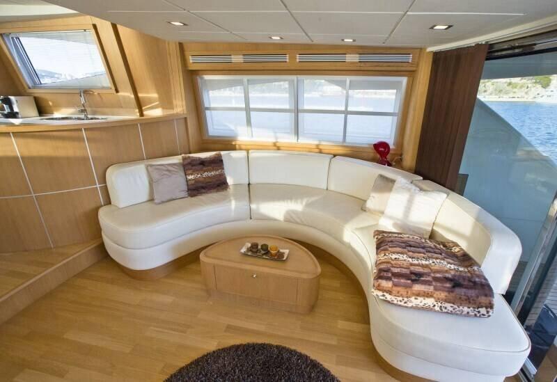 Luxurious interior of the 70 2007 yacht featuring a spacious, curved seating area with elegant decor.