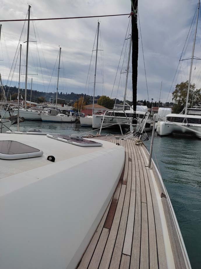 Sleek profile of Miss Elli docked in a prestigious marina, showcasing elegant teak decking.