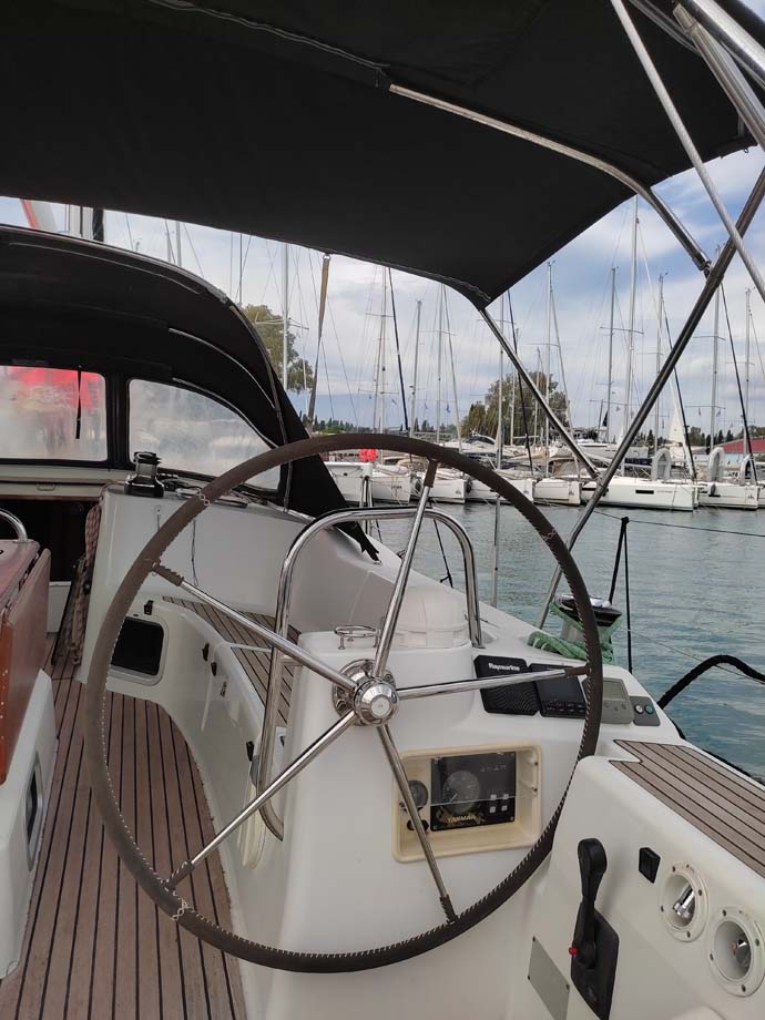 Sleek helm of Miss Elli, showcasing elegant design and premium materials in a marina setting.