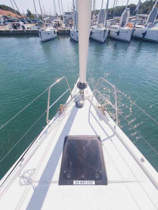 Sombra del Viento anchored in a tranquil marina, showcasing sleek lines and polished deck.