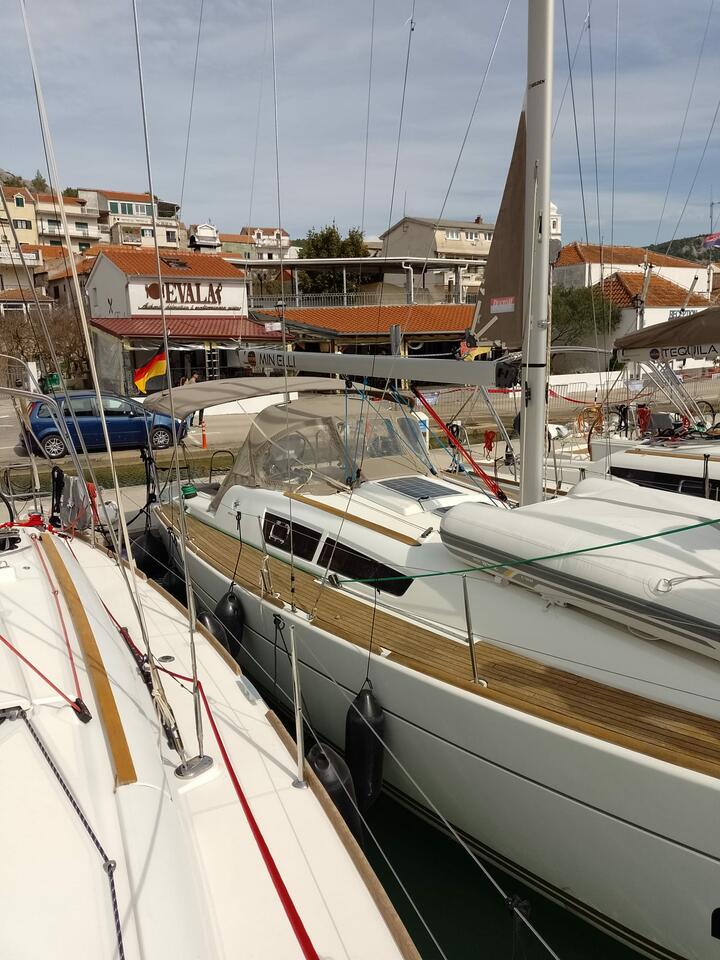 Min Elli docked in a bustling marina, showcasing its elegant lines and luxurious finish.
