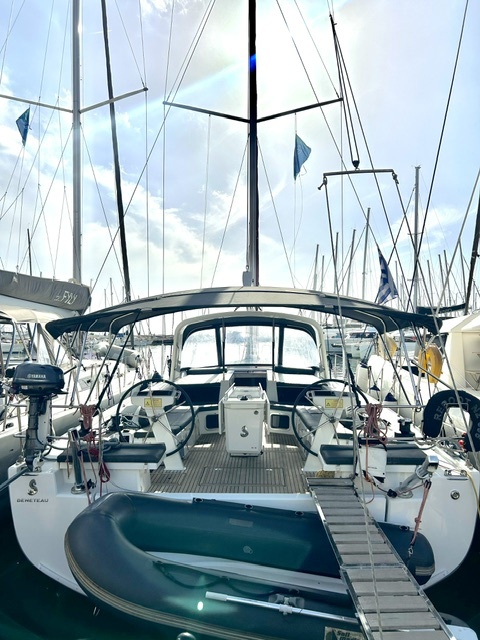 Spacious cockpit of Reboot showcasing elegant seating and premium finishes in a marina setting.