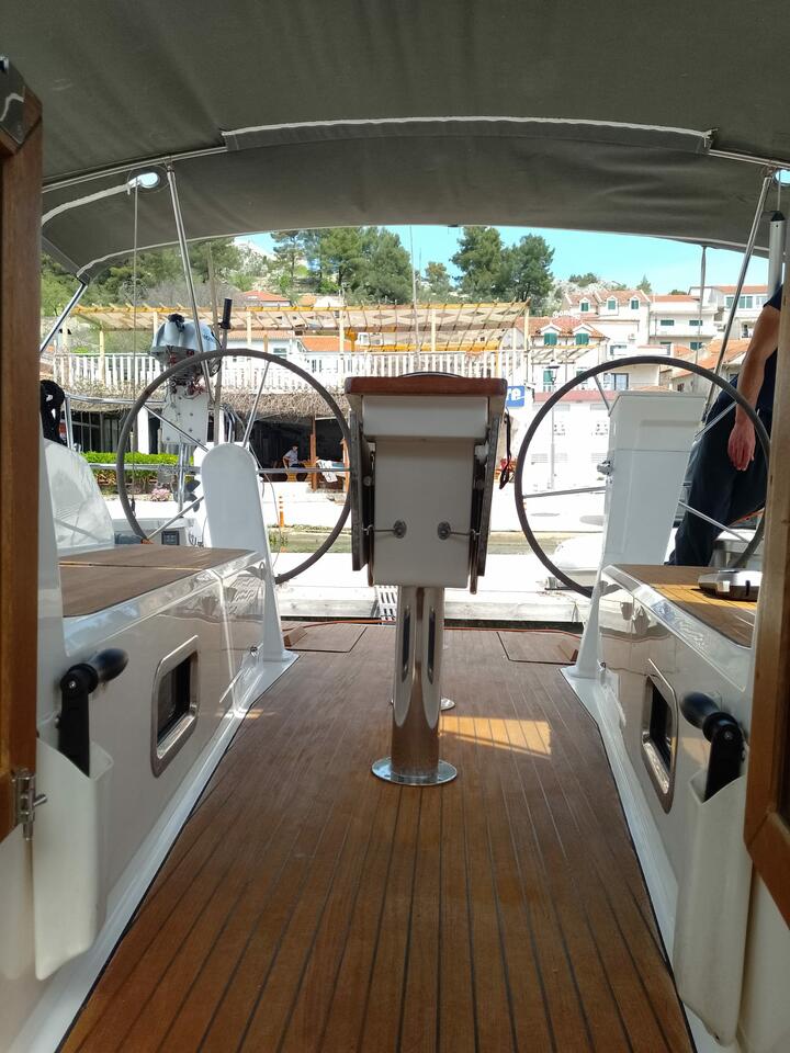 Spacious helm area of Summer Elli, featuring polished wood and modern steering controls.