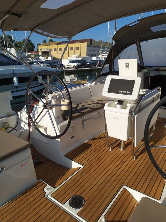 Sleek helm station of Mango Tango featuring modern controls and elegant teak decking.