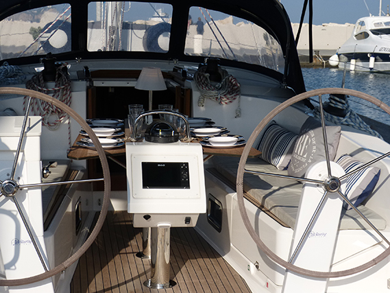 Sophisticated interior of Xenia featuring elegant dining setup and modern navigation controls.