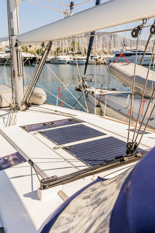 Solar panels on the deck of Maryalis, showcasing modern sustainability in a marina setting.