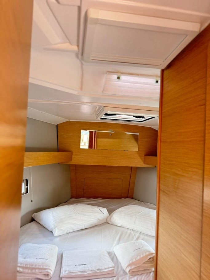 Cozy cabin aboard Theodora featuring warm wood finishes and ample natural light.