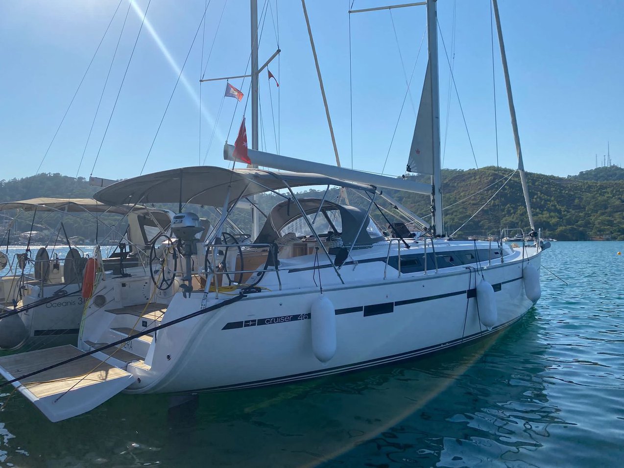Elegant profile of the Hera yacht gliding through crystal-clear waters, showcasing its sleek hull design.