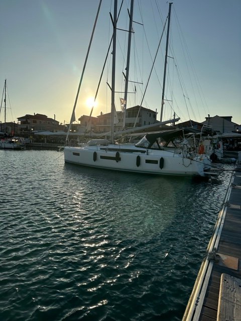Ecstasea docked at sunset, showcasing its sleek profile and serene marina setting.
