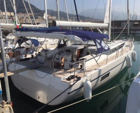 Elegant Alnair docked, showcasing its sleek hull and inviting deck layout.