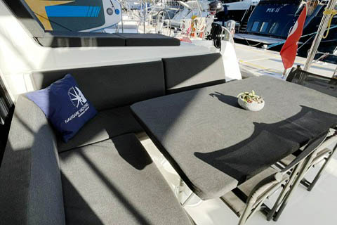 Luxurious outdoor seating area on NORD, featuring plush cushions and elegant table setting.