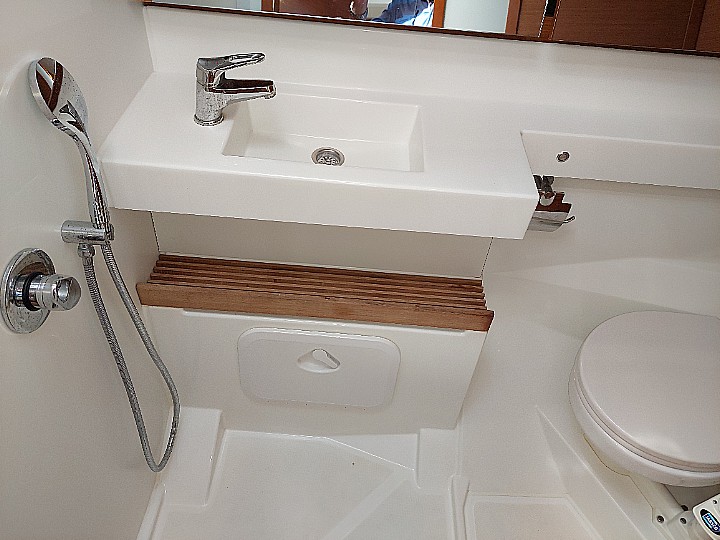 Sleek, modern bathroom in Olympia featuring elegant fixtures and warm wooden accents.