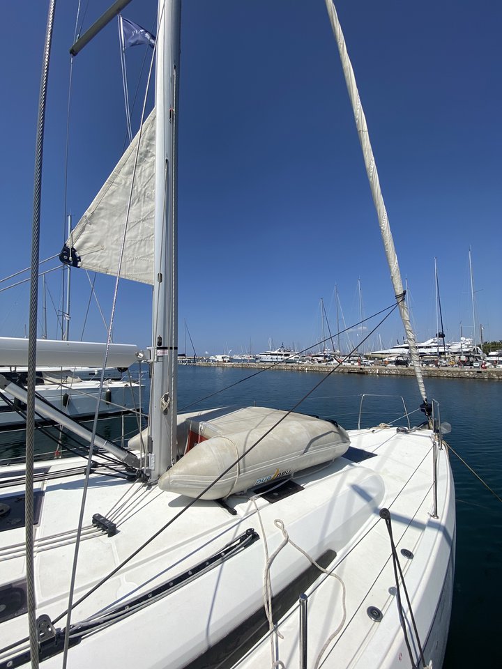 ARIA sailing gracefully in a sunny marina, showcasing its sleek hull and elegant sails.