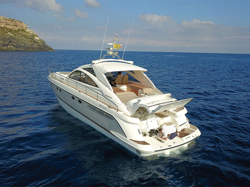 Sleek profile of the Katrin yacht gliding through crystal-clear waters under a bright sky.
