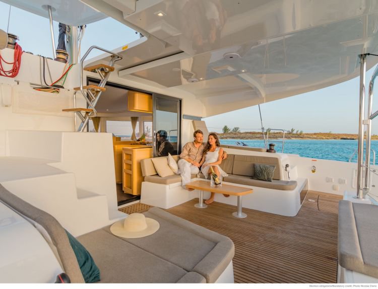 Elegant interior of Pirelli yacht featuring cozy seating and modern kitchen, perfect for relaxation.