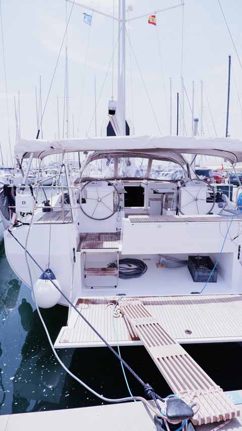 Spacious cockpit of Juana showcasing elegant design and premium materials in a marina setting.