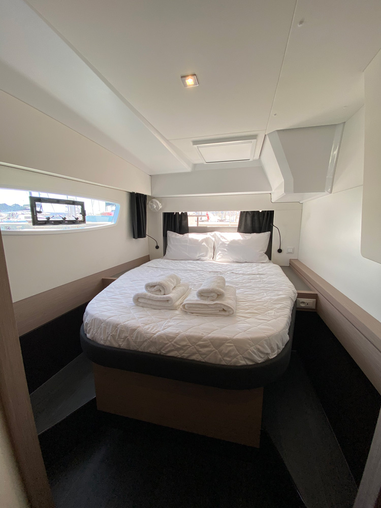 Luxurious cabin on ION featuring elegant bedding, modern design, and ample natural light.
