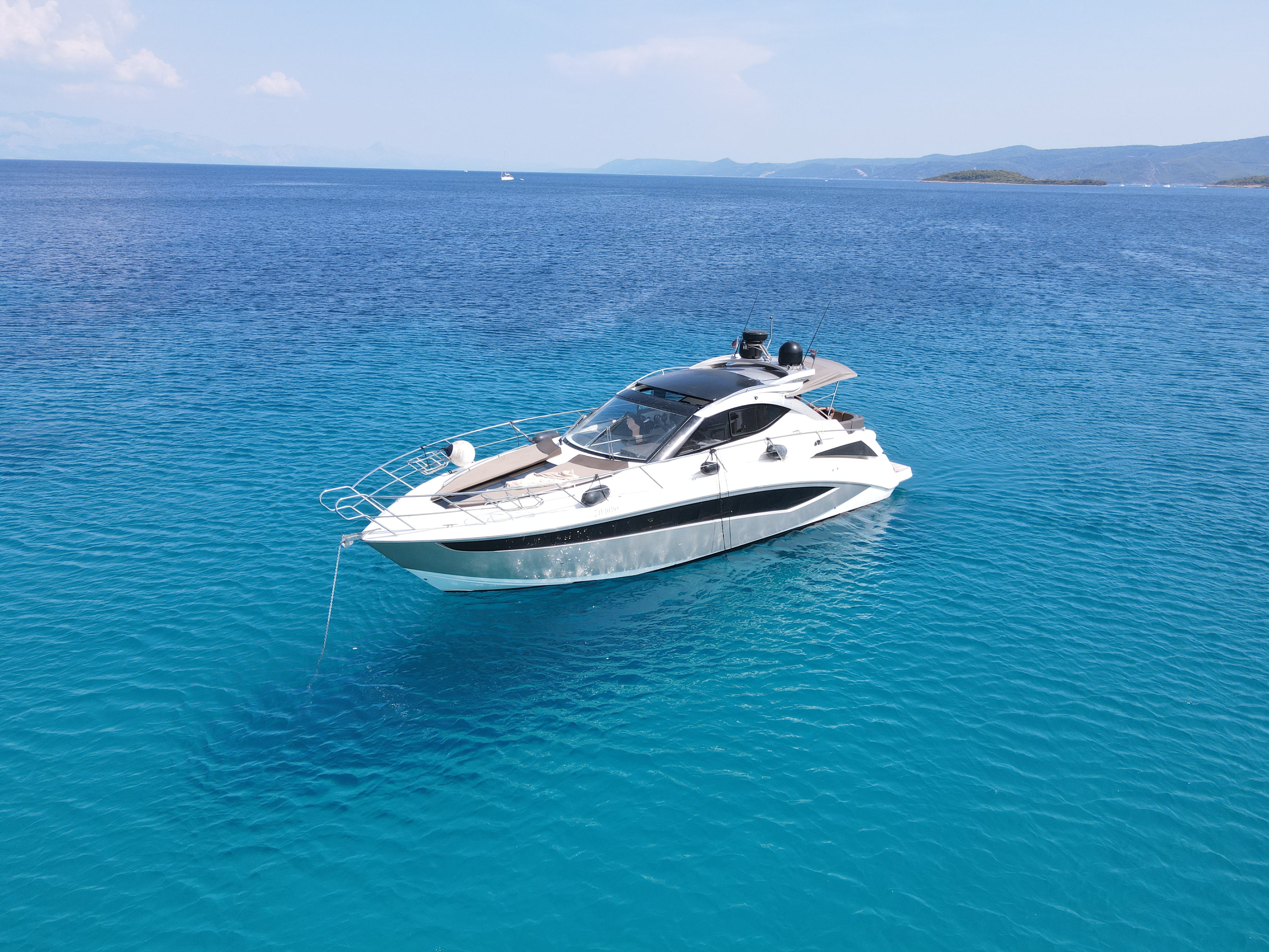 Elegant Manoli gliding through crystal-clear waters, showcasing its sleek profile and luxurious design.