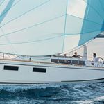 Philyra gracefully sailing with vibrant sails, showcasing elegance on the open water.