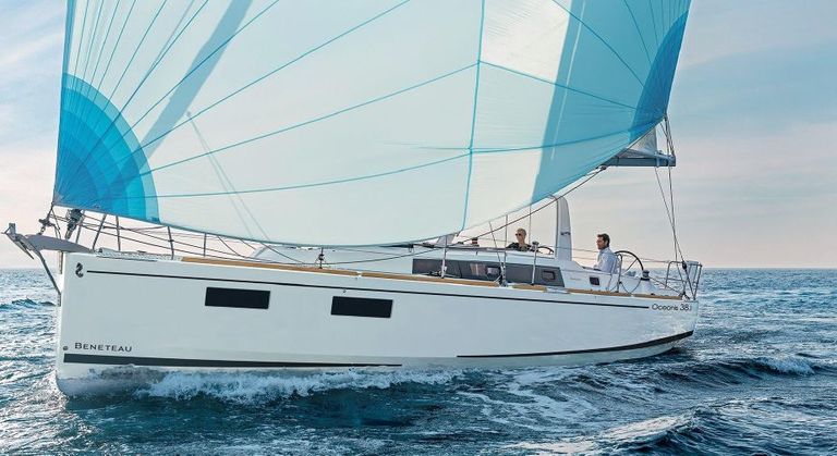 Philyra gracefully sailing with vibrant sails, showcasing elegance on the open water.
