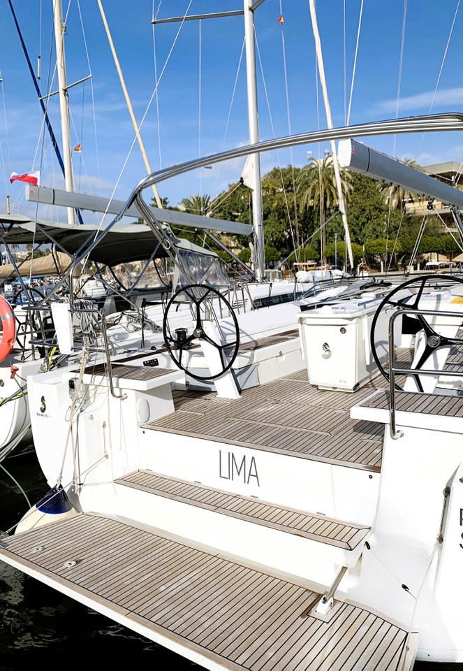Stylish cockpit of the Lima yacht featuring dual steering wheels and elegant teak decking.