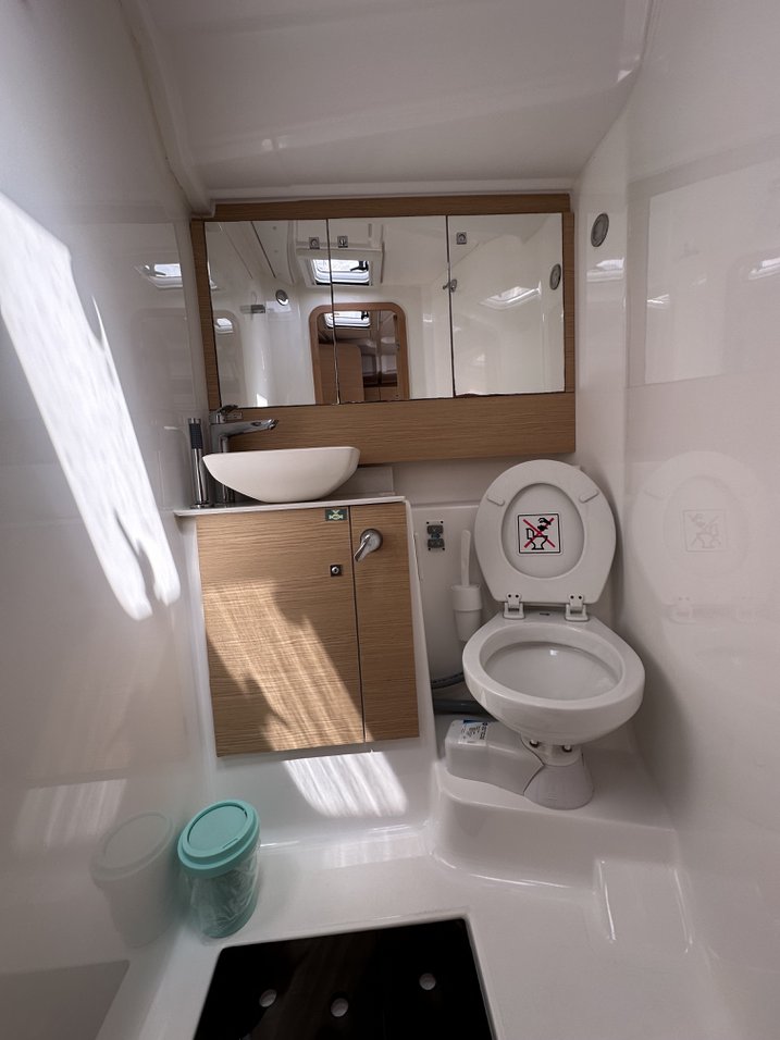 Elegant bathroom aboard Enki featuring modern fixtures, sleek surfaces, and natural light.