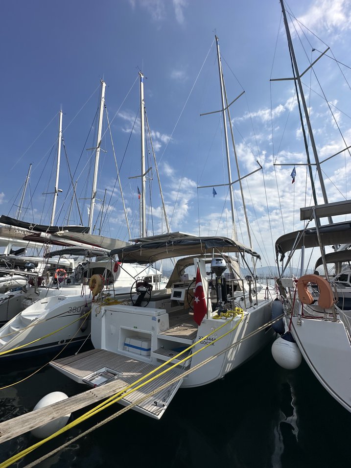 Elegant Enki moored in a vibrant marina, showcasing its sleek lines and luxurious design.