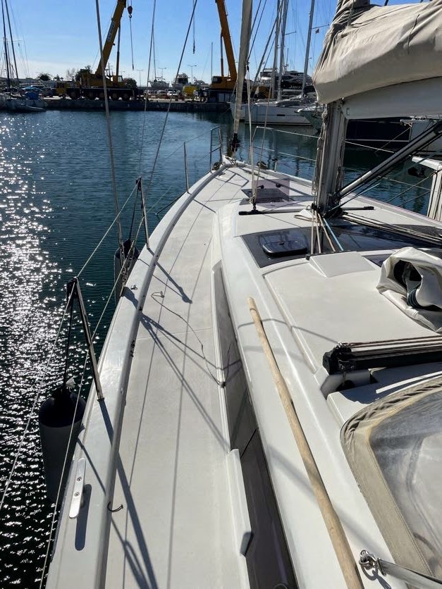 Sleek profile of Gin Fizz glistening under sunlight, showcasing its elegant deck and hull.