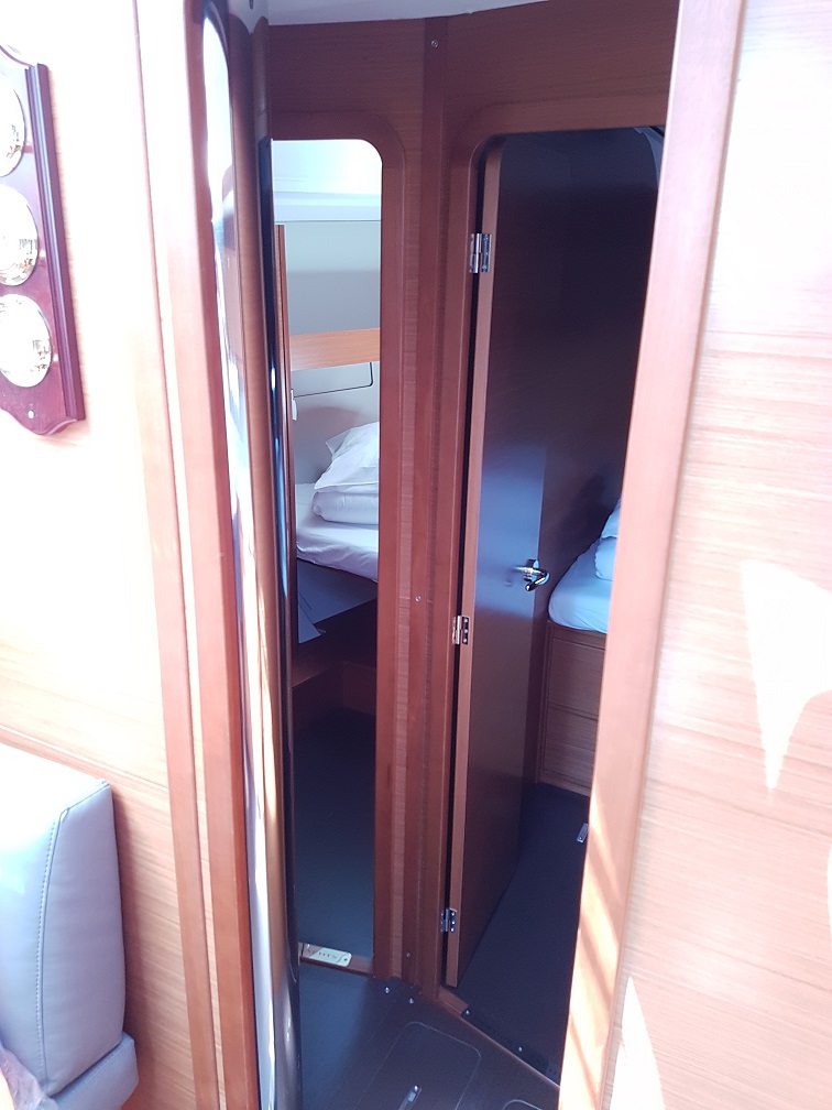Elegant cabin entrance on Alegro, showcasing rich wood finishes and modern design.