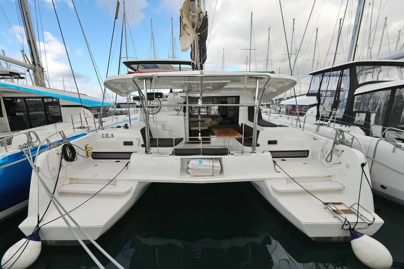 Sleek stern view of Lila showcasing elegant lines and spacious outdoor living area.