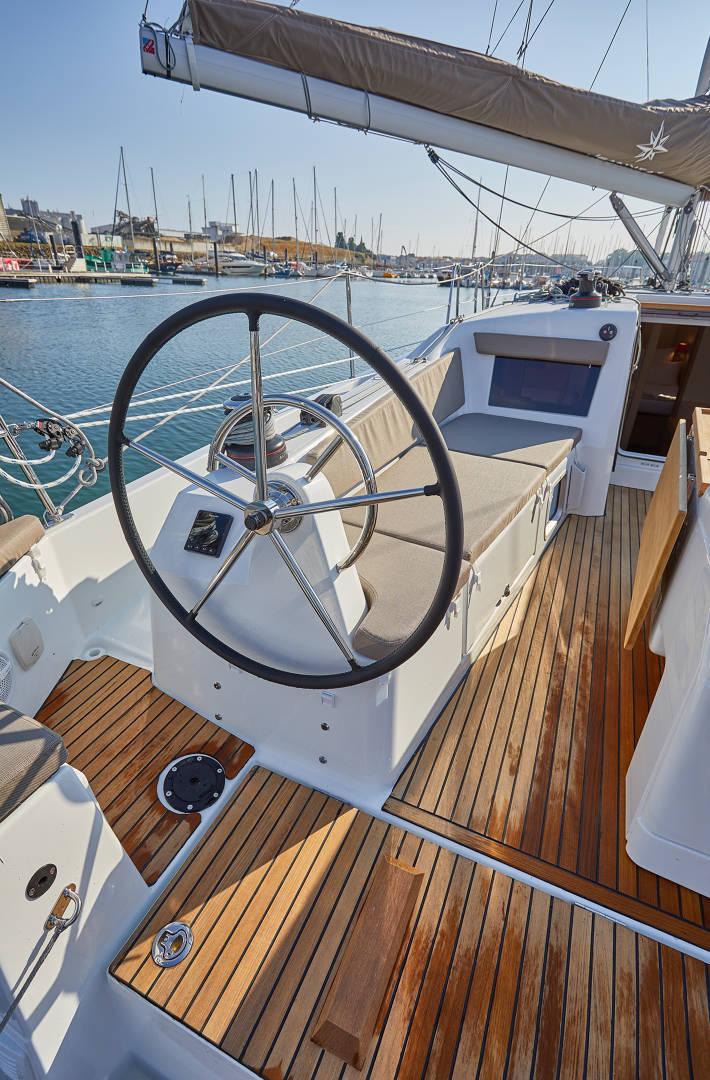 Sleek helm station on Oliver, featuring polished wood decking and modern navigation equipment.