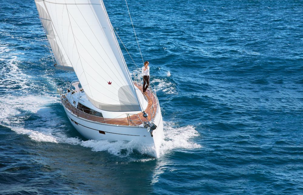 Natti gracefully sailing through vibrant blue waters, showcasing its elegant hull and sails.