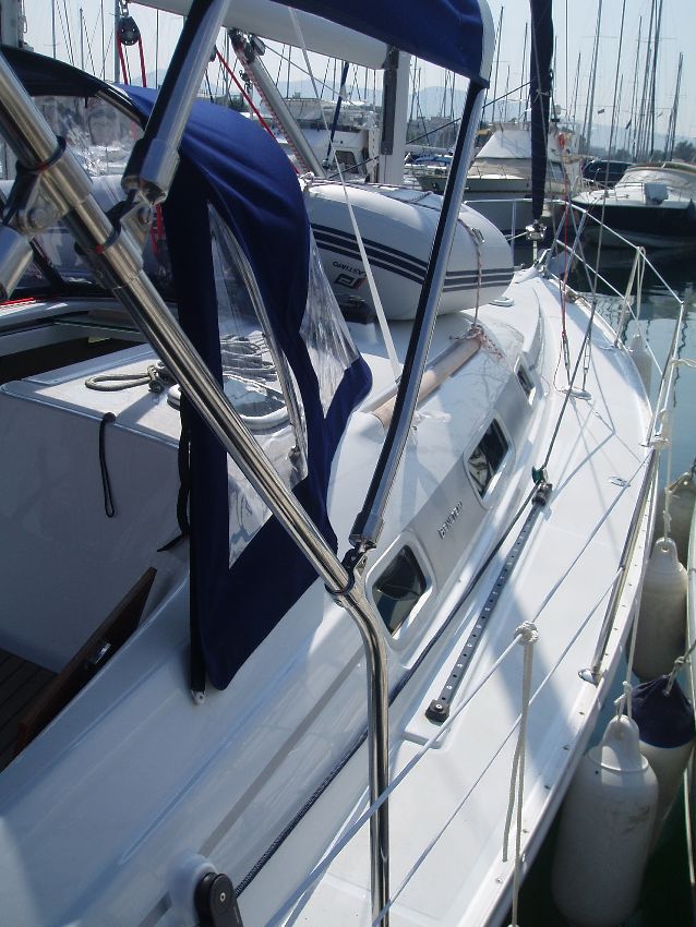 Sleek profile of Naysika showcasing polished hull and elegant lines in marina setting.