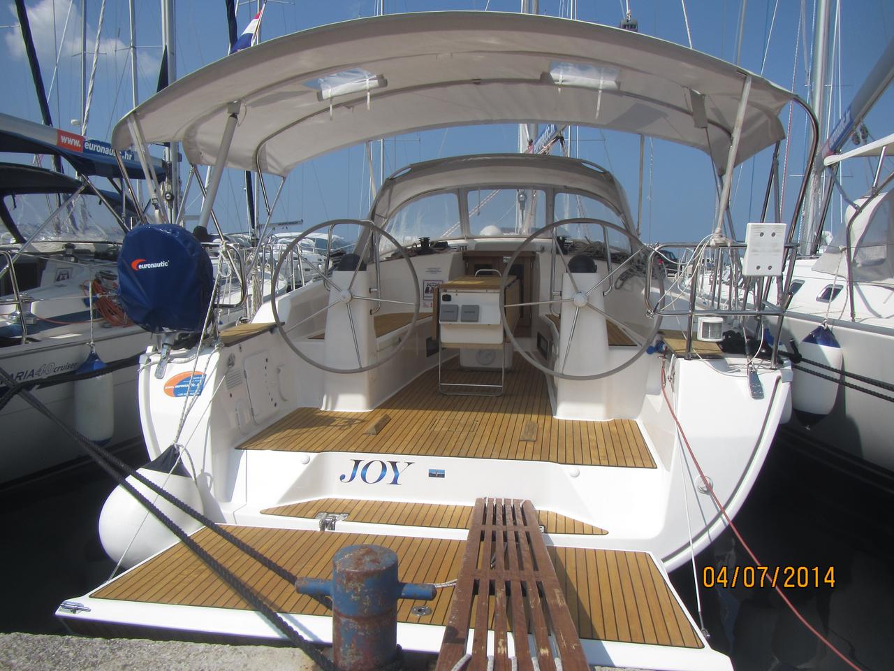 Spacious and elegant cockpit of Joy featuring teak decking and modern helm controls.